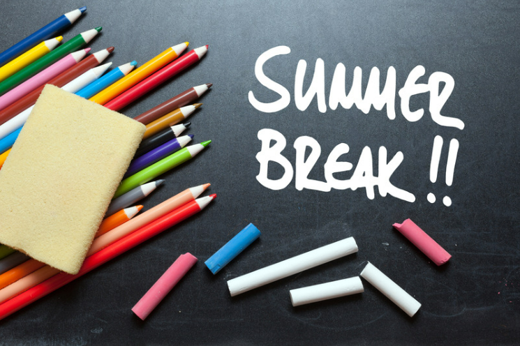 colored pencils and chalk laying on chalk board surface with phrase "summer break!!"