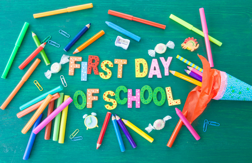 text "first day of school" surrounded by school supplies